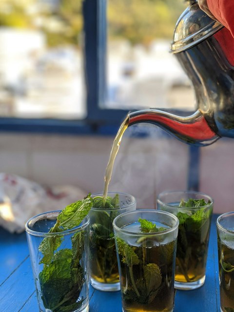 mint tea being poured into glasses
